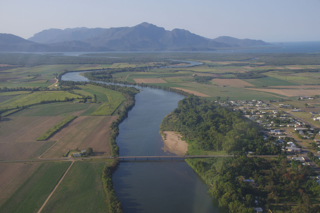 The Herbert River is bordered by cane fields. Credit: HCPSL
