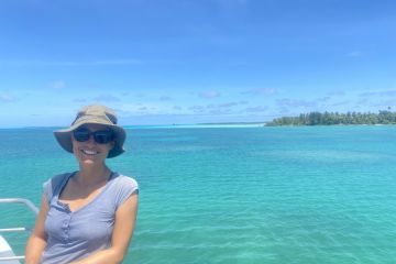 Kristina Koenig smiling on a boat by the Reef.