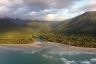 Aerial view of a rainforest meeting the ocean